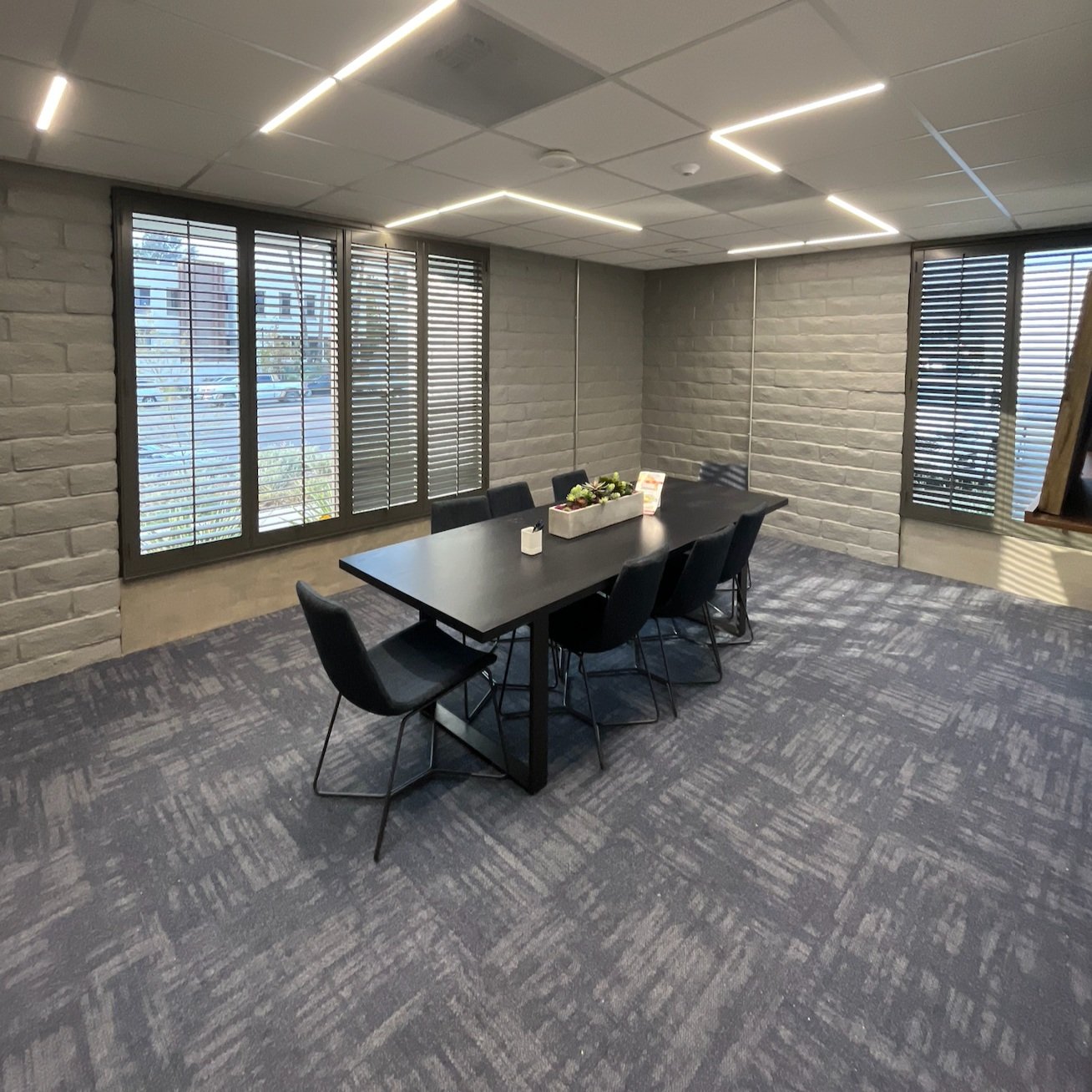 Modern office conference room with white brick walls